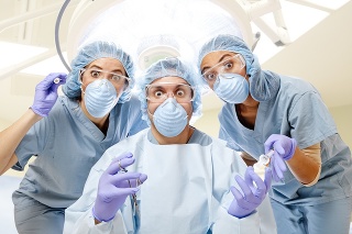 Wide-eyed surgery team in operating room.