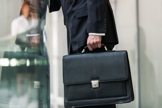 Leather briefcase held by a man.