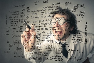 Mathematician is writing financial figures on a board