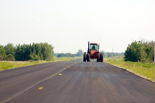 A large tractor going down a country road...FARMING COUNTRY!