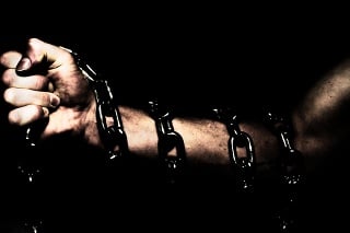 Person's Arm Wrapped in Chains and Scared Woman
