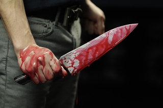 Close up of knife with blood dripping
