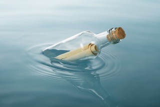 message in a bottle floating on water