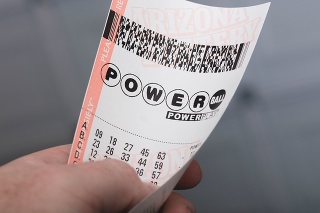 Kingman, USA - January 20, 2016: A photo of a man holding a Powerball lottery ticket in Kingman, Arizona. 