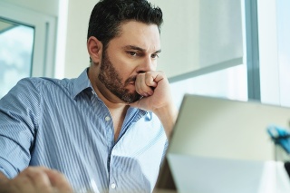 Angry Hispanic businessman working with laptop computer in office, losing patience. Anxious executive man under stress at work for technology problems and software pc virus.