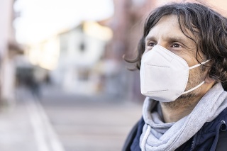 Portrait of a man wearing a protective face mask in accordance with the European health guidelines FFP2/KN95