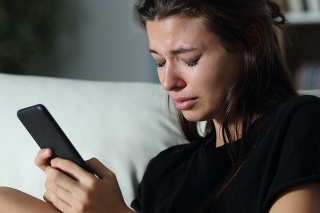 Sad teen crying after read phone message