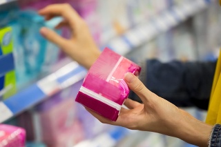Unrecognizable woman is choosing between pad and tampon in the store, selective focus 