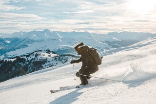 Woman free skiing in fresh powder in Laax, Switzerland.