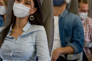 Portrait of a Latin American Woman traveling by plane wearing a facemask during the COVID-19 pandemic