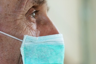 face of elderly man wearing medical facemask health safety concept