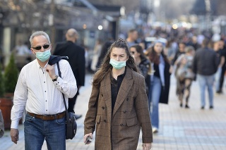 Sofia, Bulgaria - MAR 13 2020: A young woman and an older man are walking on Vitosha street. Few hours after that the Governemnt announced State of Emergency in the country because of the corona virus outbreak.