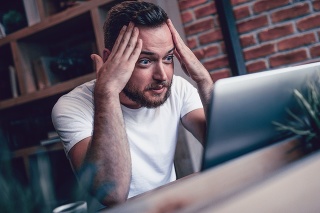 Shocked Freelancer in Disbelief Working at his Favorite Coffee Place