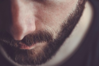 Man with beard and mustache looking down