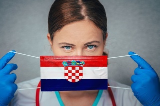 Coronavirus in Croatia Female Doctor Portrait hold protect Face surgical medical mask with Croatia National Flag. Illness, Virus Covid-19 in Croatia, concept photo