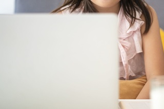 Asian girl using laptop for online study during homeschooling at home during Coronavirus or Covid-19 virus outbreak situation