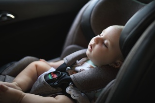 Baby sleeping in car safety seat while