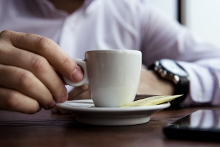 Coffe Cup Held by a Man in the Caffee Bar