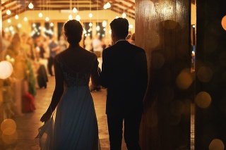 Rearview shot of a young couple arriving hand in hand at their wedding reception