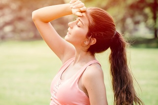 Young sport woman tired headache discomfort expression overheat from hot weather summer season.
