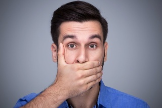 Man covering mouth