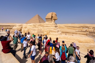 Tourists and Great Sphinx of Giza, with the Great Pyramid in the background. People take selfies. Cairo, autumn 2018