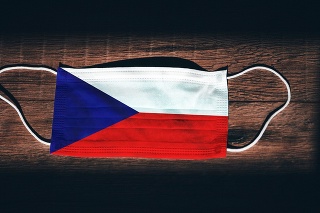 Czech Republic National Flag at medical, surgical, protection mask on black wooden background. Coronavirus Covid