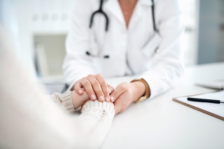 Closeup shot of an unrecognizable female doctor holding a patient's hand in comfort during a consultation inside her office