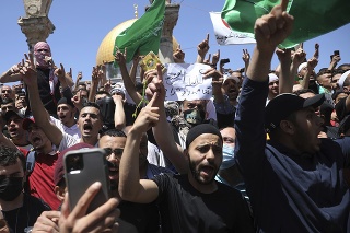 Ľudia skandujú slogany a mávajú vlajkami Hamasu počas protestu proti pravdepodobnému vysťahovaniu palestínskych rodín z ich domovov po piatkových večerných modlitbách, obvyklých počas pôstneho mesiaca ramadán pri al-Aksá, najväčšej mešite v Jeruzaleme.