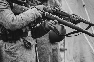 Two German soldiers of the Second World War with rifles in their hands ready to fire. Black and white photo