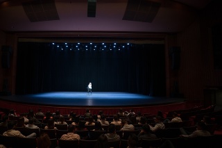 Audience enjoying a singing performance on stage at the theater