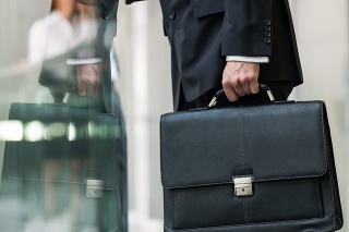 Leather briefcase held by a man.
