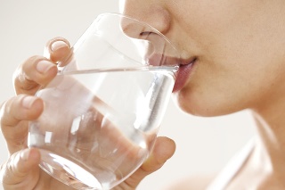 Young woman drinking  glass of water