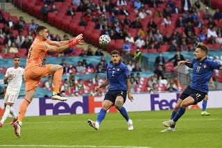 Španielsky brankár Unai Simon(vľavo) chytá loptu pred Talianom Cirom Immobileom (vpravo) v zápase semifinále Taliansko - Španielsko.
