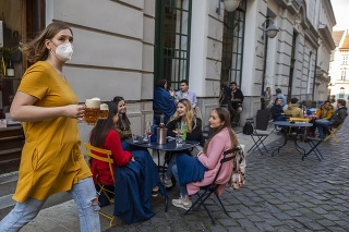 Zmiernené opatrenia: Zákazníci sedia na terase prevádzky na Nedbalovej ulici v Bratislave v pondelok 26. apríla 2021.