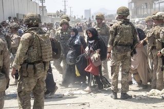 Na snímke členovia britskej a americkej armády pomáhajú počas evakuácie ľudí z Kábulu 20. augusta 2021.