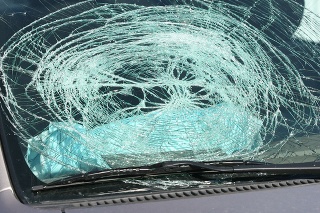 Broken windshield from airbag going off from a car accident.