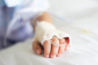 Saline intravenous (iv) drip in a Children's patient hand