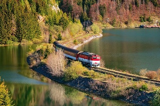 Train passing through lake near Mlynky village in the Slovak Paradise (Slovensky raj) national park, Slovakia.