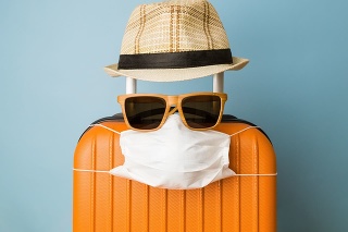 Travel restriction abstract made of tourist in form of of luggage with face mask, sunglasses and hat.