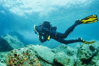 Scuba diving. Beautiful sea. Underwater scene with male scuba diver, enjoy  in blue, shallow water. Scuba diver point of view.