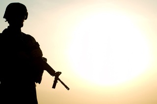 Silhouette of US soldier with rifle against a sunset