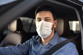 Portrait of driver wearing protective medical mask