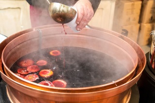 Christmas market and a pot of mulled wine with fruit and spices