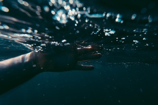 Hand stretched out in water