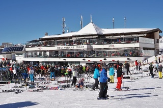 Ischgl, Austria - 7 February 2020: View of the busy Restaurant / cafe and lift station of Idalp in the Ischgl part of the Ischgl - Samnaun ski area which straddles Austria and Switzerland. Several diners are eating in the sunshine on the balcony areas.