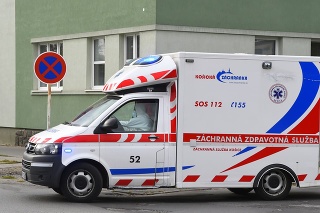 Vodič v ochrannom odeve v sanitke pred areálom Fakultnej nemocnice J. A. Reimana v Prešove