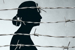 Woman Prisoner Behind Barbed Wire