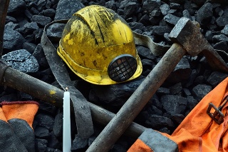 Vigil light, candle with the miner belongings (helmet, gloves, pickaxe, vest, belt) after the fatal accident in the mine