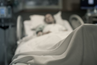 Sick woman lying in the hospital bed.